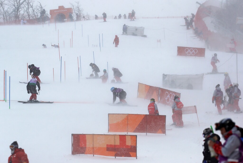 Course crew strive to prepare the women's slalom course at Yongpyong alpine center at the 2018 Winter Olympics in Pyeongchang, South Korea, Wednesday, Feb. 14, 2018. (AP Photo/Luca Bruno)