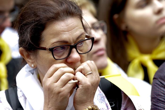(Andrew Medichini  |  AP Photo)  A woman prays with a rosary as she waits with others for the arrival of Pope Francis' visit at the Mater Misericodie Shrine, in Vilnius, Lithuania, Saturday, Sept. 22, 2018. Pope Francis urged Lithuanians to use their decades of suffering under Soviet and Nazi occupations to become models of tolerance in an intolerant world as he began a three-nation tour of the Baltics on Saturday amid renewed alarm over their giant neighbor Russia.