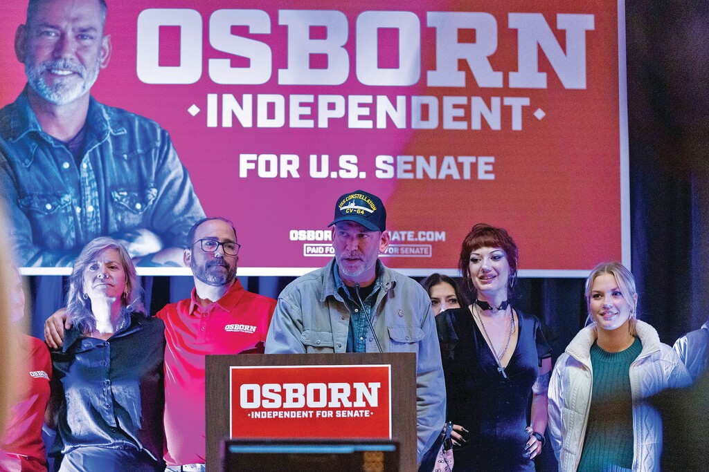 Independent Nebraska Senate candidate Dan Osborn, center, speaks at an election night watch party at the Embassy Suites by Hilton Omaha La Vista Hotel & Conference Center in La Vista, Neb., Tuesday, Nov. 5, 2024. (AP Photo/Bonnie Ryan)
