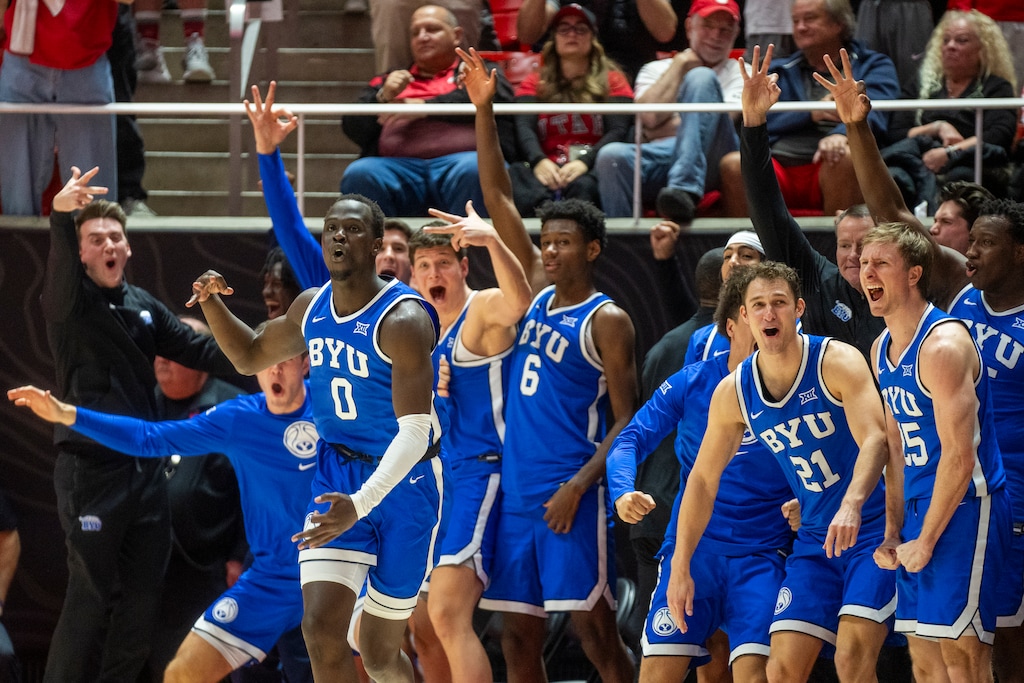 (Rick Egan | The Salt Lake Tribune) Brigham Young Cougars react after forward Mawot Mag (0) hit a big 3-point shot, in Big 12 basketball action between the Utah Utes and the Brigham Young Cougars, at the Jon M. Huntsman Center, on Saturday, Jan 18, 2025.