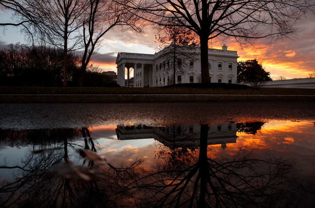 The sun rises behind the White House in Washington, Saturday, Dec. 22, 2018. Hundreds of thousands of federal workers faced a partial government shutdown early Saturday after Democrats refused to meet President Donald Trump's demands for $5 billion to start erecting a border wall with Mexico. Overall, more than 800,000 federal employees would see their jobs disrupted, including more than half who would be forced to continue working without pay. (AP Photo/Carolyn Kaster)