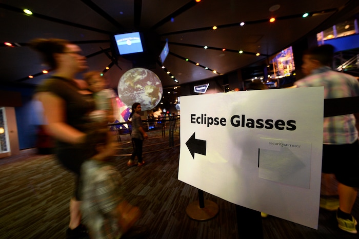 (Scott Sommerdorf | The Salt Lake Tribune) People arriving for the 10:30 planetarium show were directed around the queue set up to organize the crush of hundreds of hopeful eclipse-watchers who were lined up outside the Clark Planetarium in hopes of getting eclipse glasses from the gift shop, Thursday, August 17, 2017.