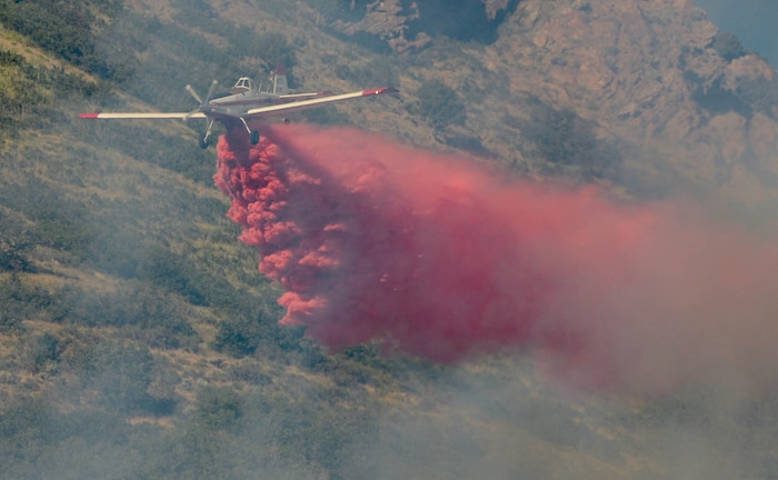 (Francisco Kjolseth  |  The Salt Lake Tribune) Fire crews battle a fire near Millcreek Canyon, on Saturday, July 11, 2020, started near 3400 South Crestwood Dr., as helicopters, single engine air tankers and multiple crews respond.