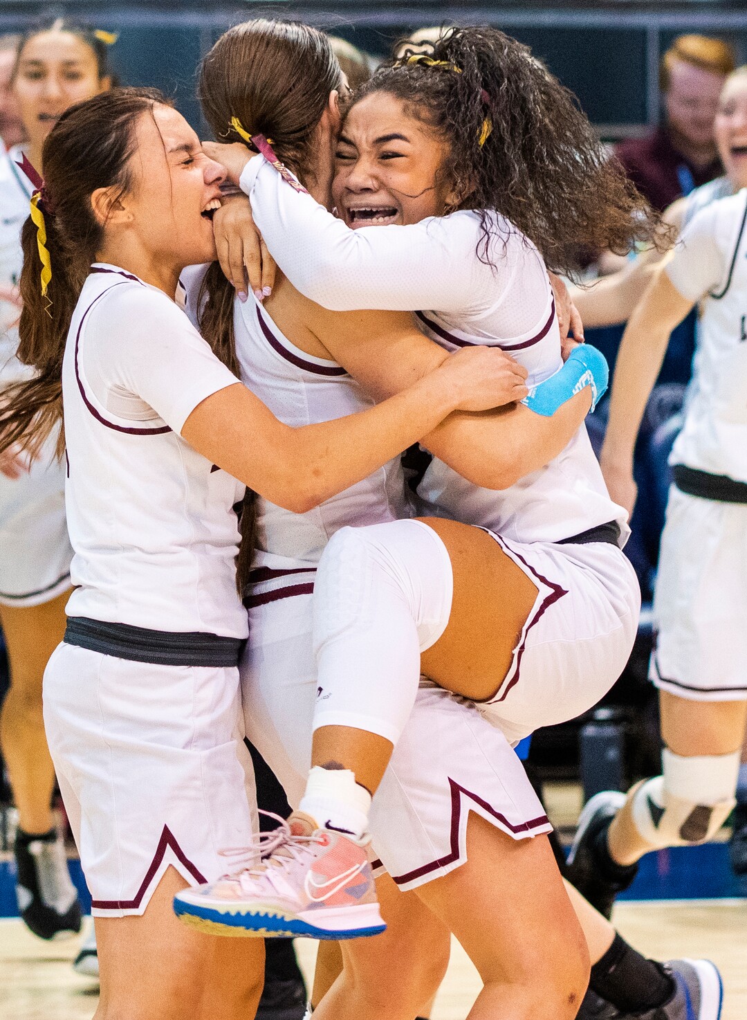 (Rick Egan | The Salt Lake Tribune) Lone Peak guard Makeili Ika leaps in to the arms of her team mates as they celebrates their 67-65 double-overtime win over Fremont, in the 6A State Championship game, at the Marriott Center in Provo, on Saturday, March 5, 2022.  Ika, hit the winning shot with .5 seconds left on the clock. 