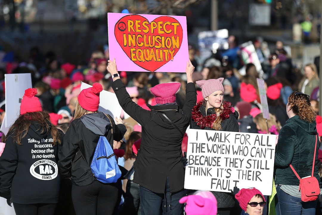 Kristyn Stickley, 22, of West Chester, Pa., at right, holds a sign during the Women's March in Philadelphia on Saturday, Jan.  20, 2018. The march is among dozens of rallies being held around the country. The activists are hoping to create an enduring political movement that will elect more women to government office. (David Maialetti /The Philadelphia Inquirer via AP)