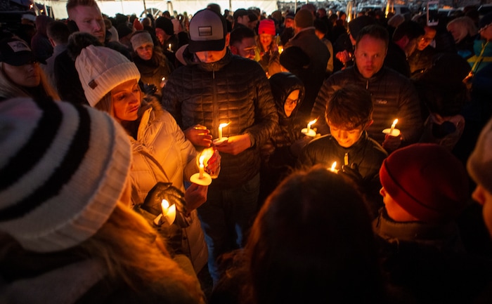 (Rick Egan  |  The Salt Lake Tribune)      Friends and loved ones of David Stokoe gather for a candlelight vigil at the RanLife Home Loans building where he worked in Sandy, Monday, Jan. 21, 2019.