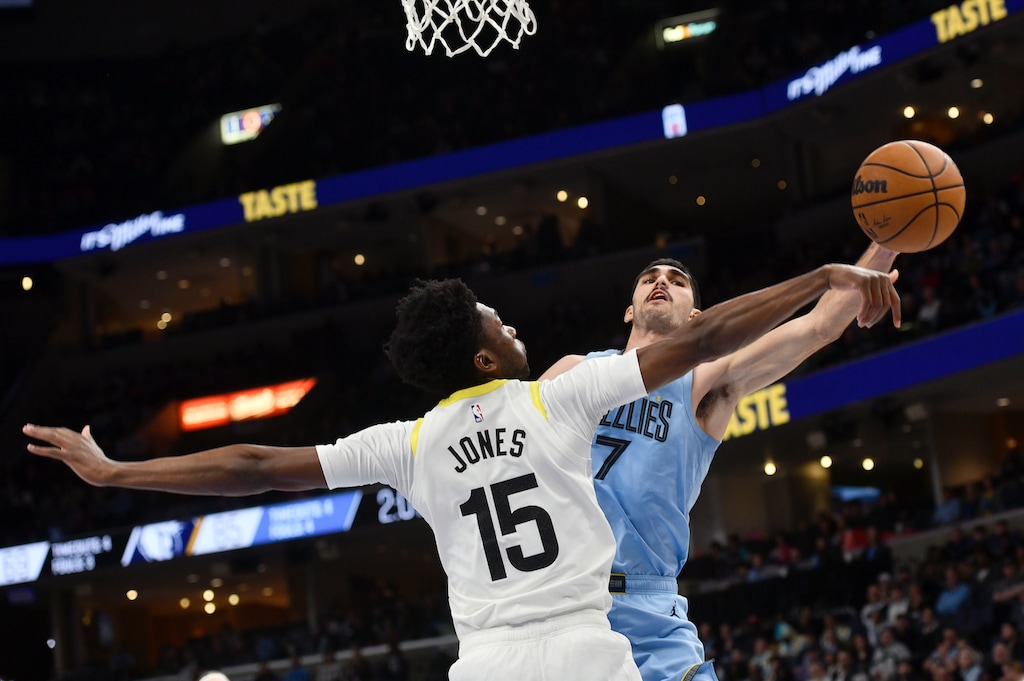 Memphis Grizzlies forward Santi Aldama (7) shoots against Utah Jazz center Damian Jones (15) during the second half of an NBA basketball game Wednesday, Feb. 15, 2023, in Memphis, Tenn. (AP Photo/Brandon Dill)