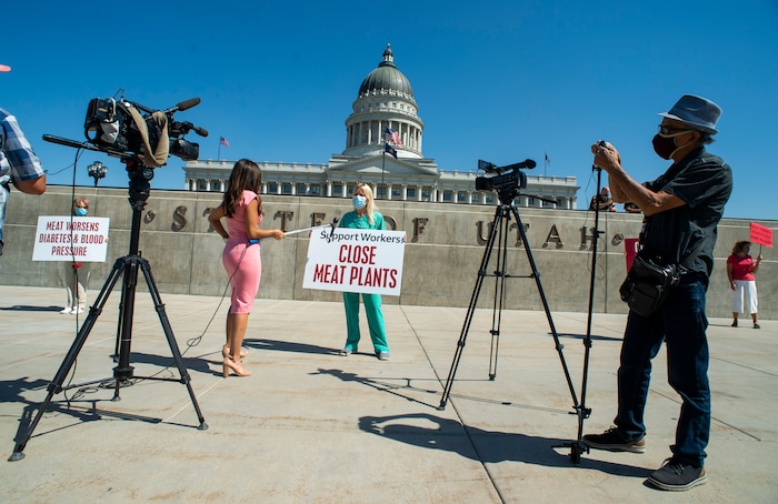 (Rick Egan | The Salt Lake Tribune) News Media interviews Niki Davis, as she joins a protest at the State Capitol as the Physicians Committee for Responsible Medicine is asking Gov. Herbert to close meatpacking plants in the state to slow the spread of the coronavirus, Thursday, July 30, 2020.