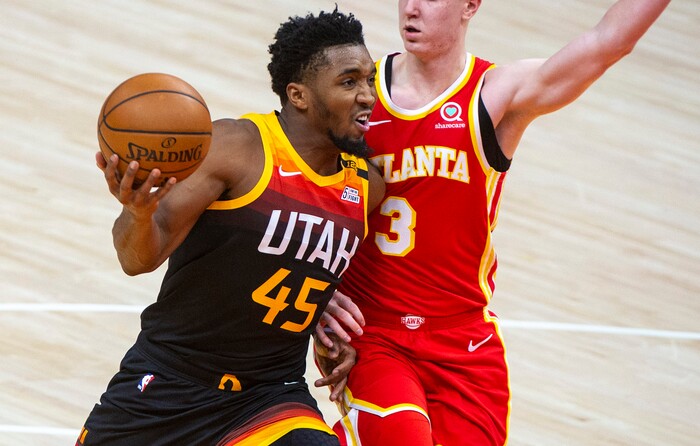 (Rick Egan | The Salt Lake Tribune) Utah Jazz guard Donovan Mitchell (45) takes the ball up the middle as Atlanta Hawks guard Kevin Huerter (3) defends, in NBA action between the Utah Jazz and the Atlanta Hawks at Vivint Arena, on Friday, Jan. 15, 2021. Mitchell scored 20 points in the first half.