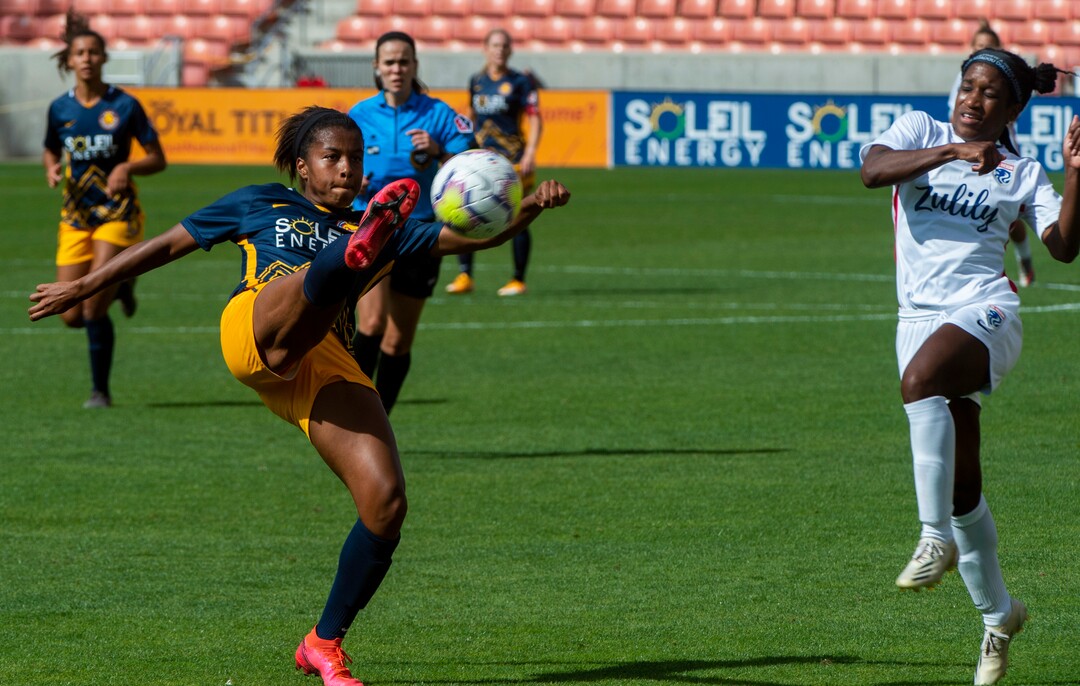 (Rick Egan  |  The Salt Lake Tribune) Utah Royals FC midfielder  Elizabeth Ball (7) kicks the ball as OL Reign FC forward Jasmyne Spencer (22) defends, in soccer action between Utah Royals FC and Ol Reign FC at Rio Tinto Stadium in Sandy, Saturday, Sept. 26, 2020.