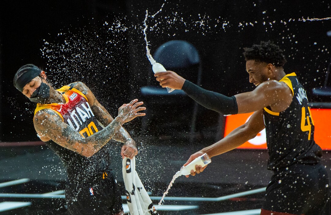 (Rick Egan | The Salt Lake Tribune)  Utah Jazz guard Donovan Mitchell (45) soaks Utah Jazz guard Jordan Clarkson (00) in the middle of his post game interview, after Clarkson's 40 point game, in NBA action between the Utah Jazz and the Philadelphia 76ers at Vivint Arena, on Monday, Feb. 15, 2021.