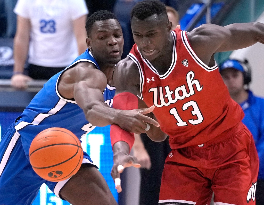 (Leah Hogsten | The Salt Lake Tribune) Brigham Young Cougars forward Atiki Ally Atiki (4) and Utah Utes center Keba Keita (13) fight for a loose ball as Brigham Young University hosts University of Utah in Provo, Dec. 17, 2022. 