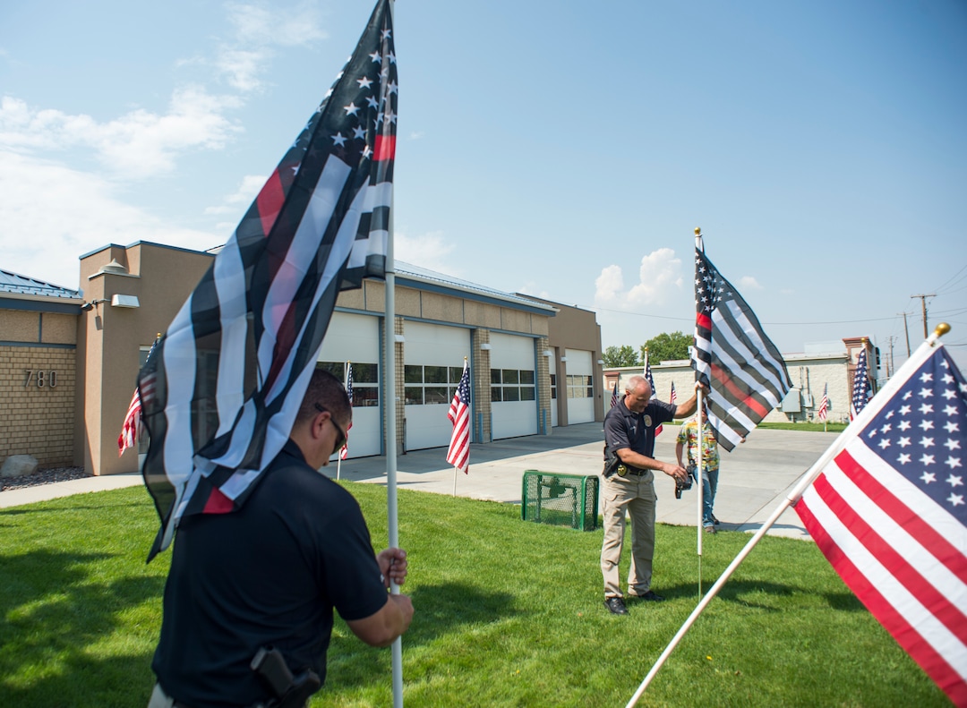 (Rick Egan  |  The Salt Lake Tribune)      Thin Red line flags are posted at the Draper Fire Station in memory of Draper firefighter Matt Burchett, 42, who died fighting wildfires in California. Tuesday, Aug. 14, 2018.