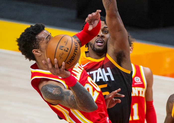 (Rick Egan | The Salt Lake Tribune) Atlanta Hawks forward John Collins (20) shoots as Utah Jazz center Derrick Favors (15) defends, in NBA action between the Utah Jazz and the Atlanta Hawks at Vivint Arena, on Friday, Jan. 15, 2021.