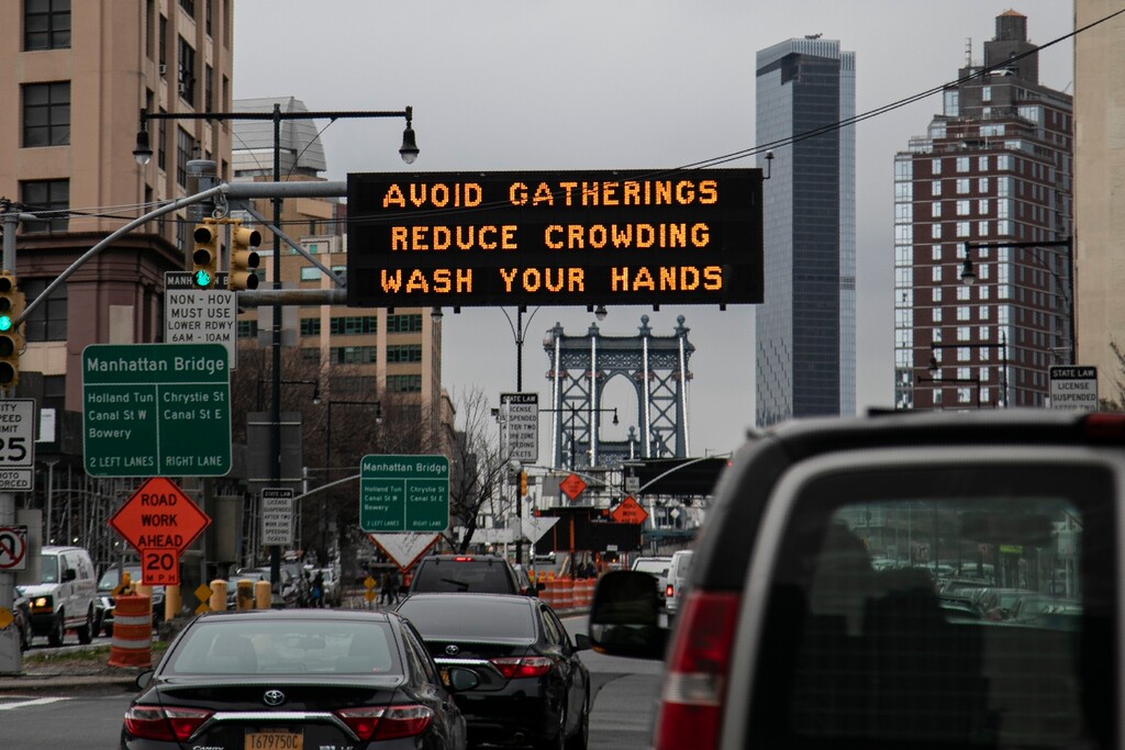 (Wong Maye-E | AP) The Manhattan bridge is seen in the background of a flashing sign urging commuters to avoid gatherings, reduce crowding and to wash hands in the Brooklyn borough of New York, on Thursday, March 19, 2020. In a matter of days, millions of Americans have seen their lives upended by measures to curb the spread of the new coronavirus. For most people, the new coronavirus causes only mild or moderate symptoms. For some it can cause more severe illness.