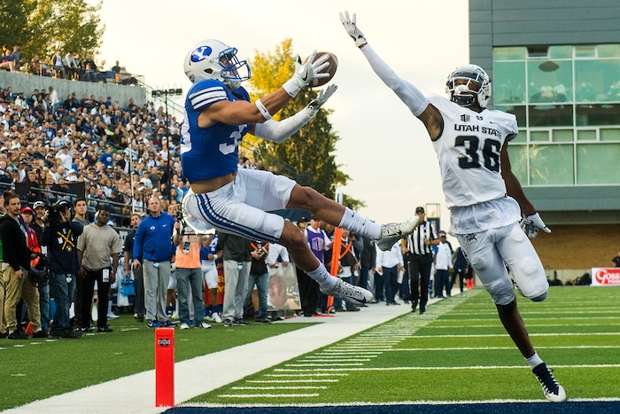 (Chris Detrick  |  The Salt Lake Tribune)  Brigham Young Cougars wide receiver Beau Tanner (33) makes a touchdown catch past Utah State Aggies cornerback Ja'Marcus Ingram (36) during the game at Merlin Olsen Field at Maverik Stadium Friday, September 29, 2017.
