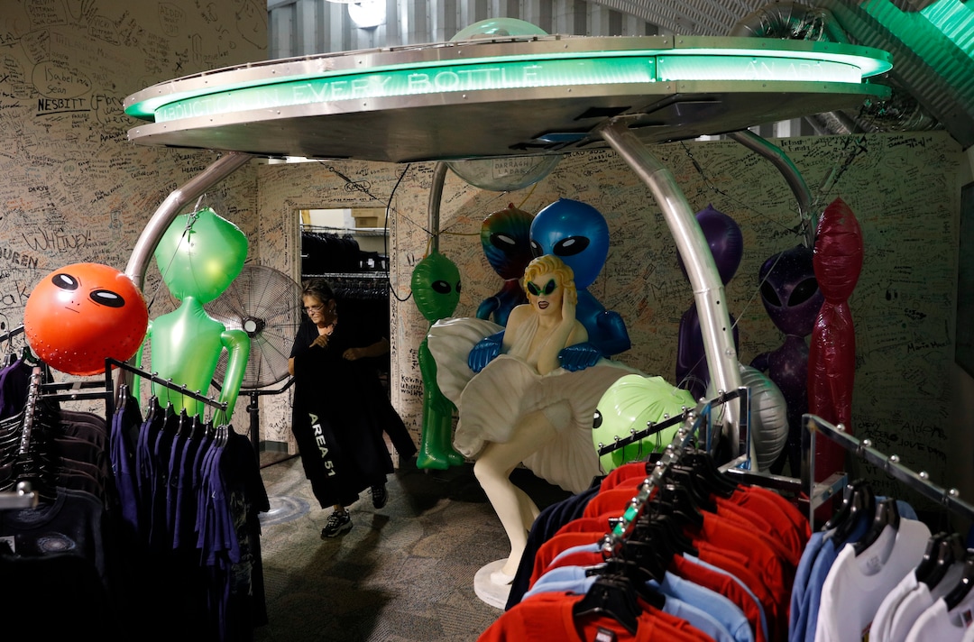 (John Locher | AP Photo) In this July 22, 2019 photo, Linda Looney restocks shirts at the Alien Research Center, a gift shop on the Extraterrestrial Highway, in Crystal Springs, Nev. The U.S. Air Force has warned people against participating in an internet joke suggesting a large crowd of people "storm Area 51," the top-secret Cold War test site in the Nevada desert.