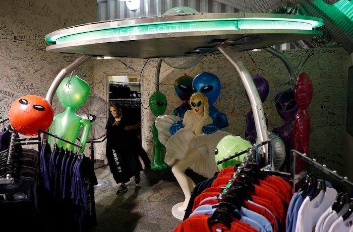 (John Locher | AP Photo) In this July 22, 2019 photo, Linda Looney restocks shirts at the Alien Research Center, a gift shop on the Extraterrestrial Highway, in Crystal Springs, Nev. The U.S. Air Force has warned people against participating in an internet joke suggesting a large crowd of people "storm Area 51," the top-secret Cold War test site in the Nevada desert.