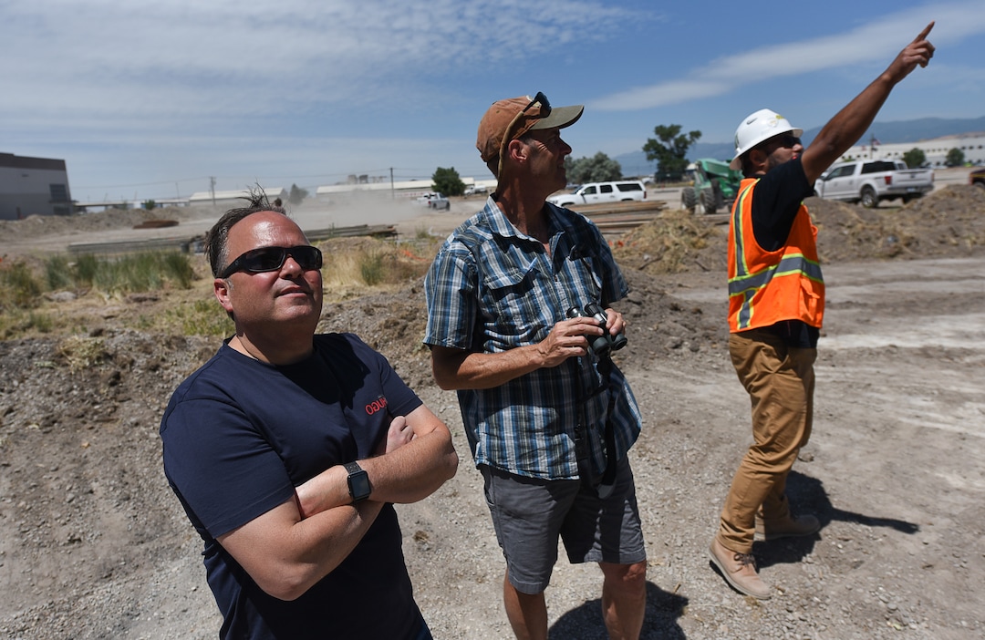 (Francisco Kjolseth  |  The Salt Lake Tribune)  Chris Mantas, left, is joined by Tim Begue and Lolo Tenifa as they spot red-tailed hawks in a cluster of large cottonwood trees in west Salt Lake City. Mantas originally planned to rip out the trees to make way for a new building. Several neighbors persuaded him to save the trees, which have been a nesting area for red-tailed hawks.