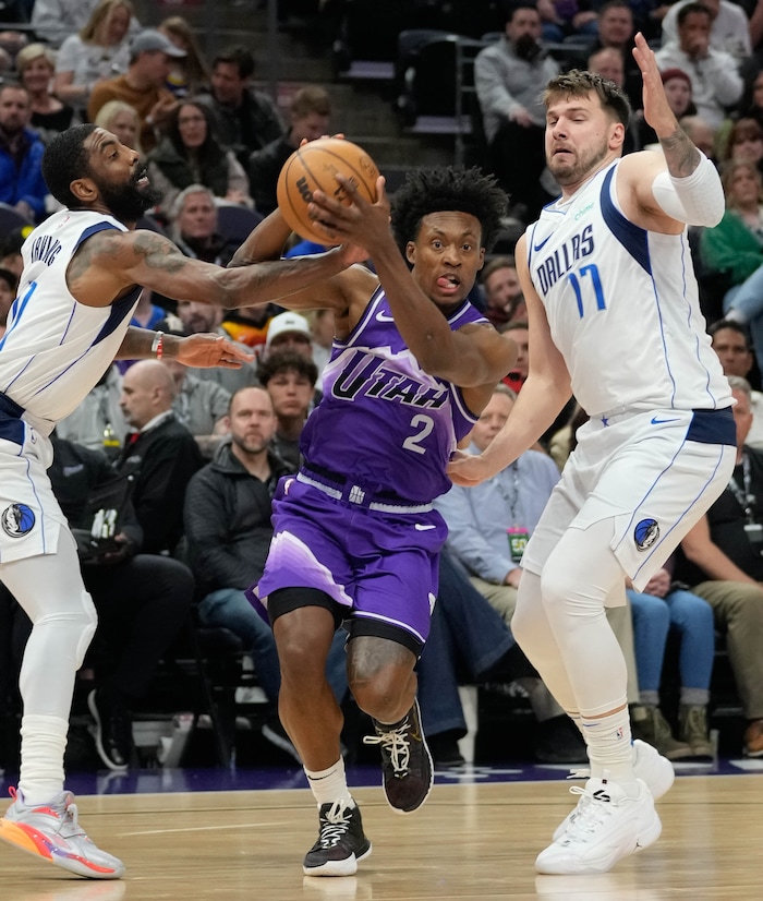 (Francisco Kjolseth  |  The Salt Lake Tribune) Utah Jazz guard Collin Sexton (2) pushes past Dallas Mavericks guard Kyrie Irving (11) and Dallas Mavericks guard Luka Doncic (77) during an NBA basketball game Monday, March 25, 2024, in Salt Lake City.