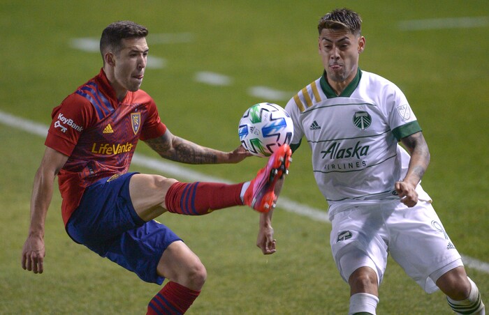 (Leah Hogsten  |  The Salt Lake Tribune) Real Salt Lake defender Aaron Herrera (22) gets a foot on the ball before Portland Timbers forward Felipe Mora (9) as Real Salt Lake hosts the Portland Timbers, Oct. 14, 2020.
