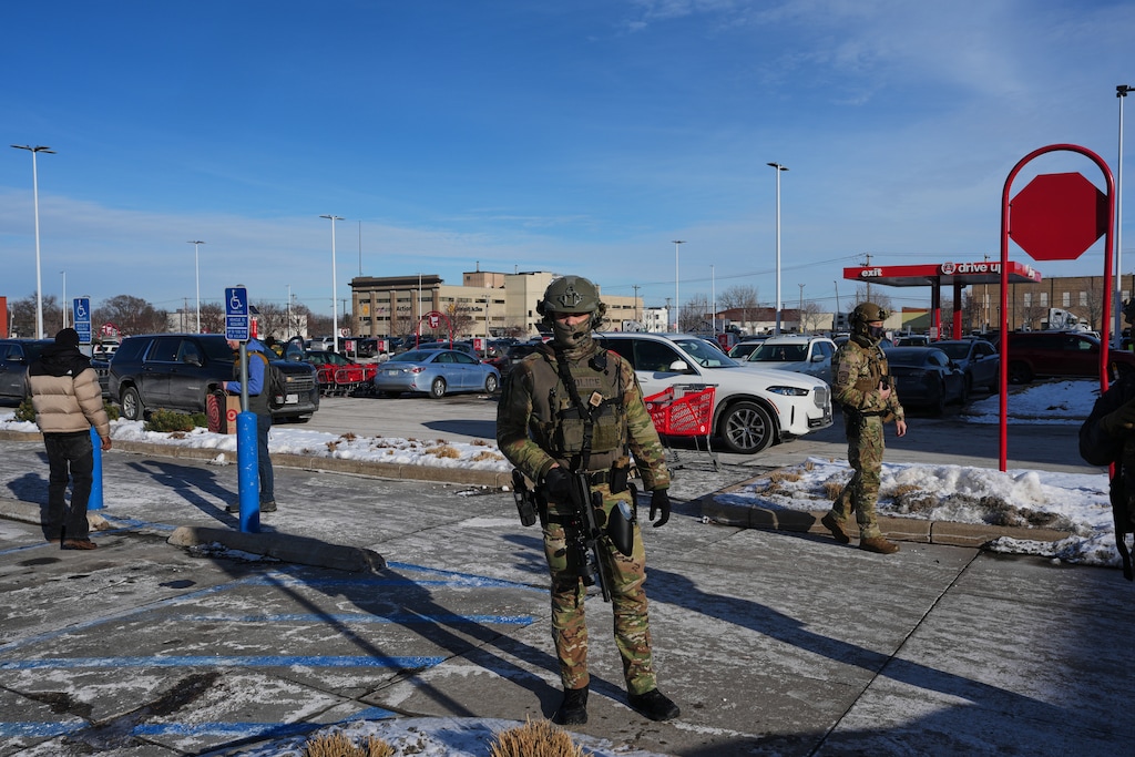U.S. Customs and Border Protection agents are seen outside of a Target store Sunday, Jan. 11, 2026, in St. Paul, Minn. (AP Photo/Adam Gray)