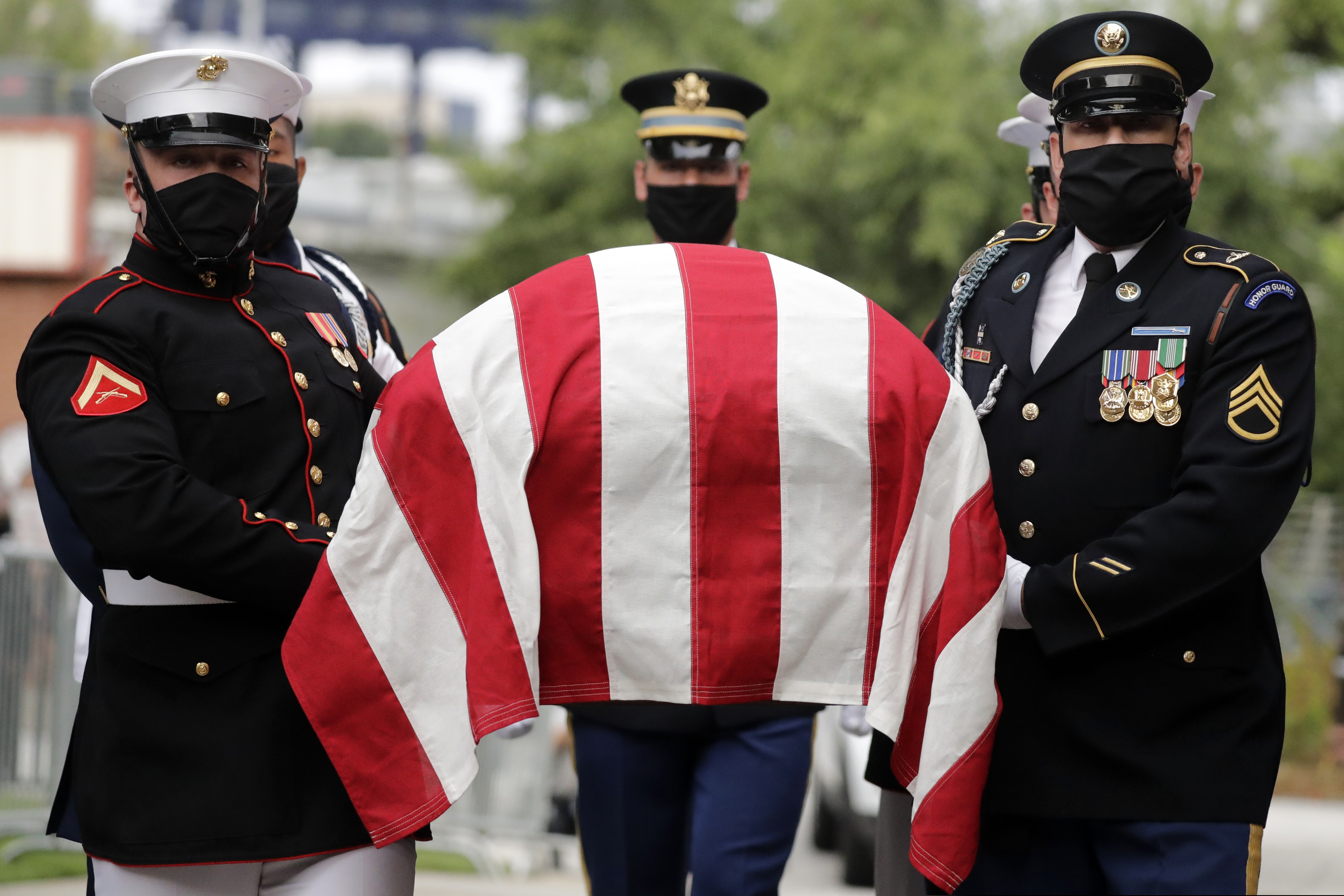 A military honor guard moved the casket of Rep. John Lewis into Ebenezer Baptist Church for his funeral, Thursday, July 30, 2020, in Atlanta. Lewis, who carried the struggle against racial discrimination from Southern battlegrounds of the 1960s to the halls of Congress, died Friday, July 17, 2020. (AP Photo/Brynn Anderson)