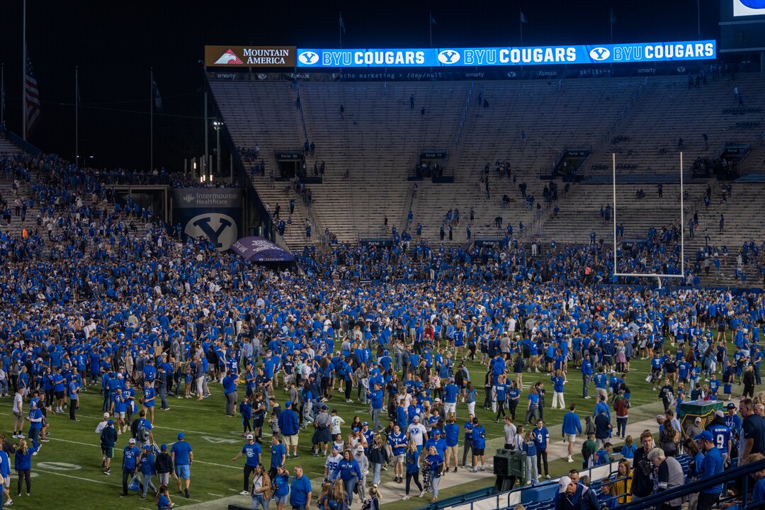 (Rick Egan | The Salt Lake Tribune) Brigham Young Cougars fans flood the field as they celebrate the BYU win over the Baylor Bears in double-overtime, at Lavell Edwards Stadium in Provo, on Saturday, Sept. 10, 2022.