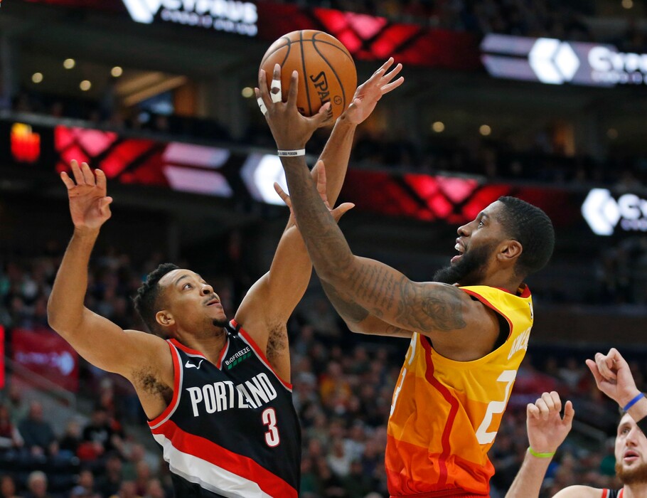 Portland Trail Blazers guard CJ McCollum (3) defends as Utah Jazz forward Royce O'Neale, right, goes to the basket during the first half in an NBA basketball game Monday, Jan. 21, 2019, in Salt lake City. (AP Photo/Rick Bowmer)