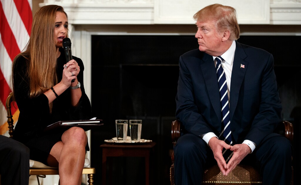 President Donald Trump looks to Julia Cordover, the student-body president at Marjory Stoneman Douglas High School in Parkland, Fla., as she speaks during the listening session with high-school students, teachers and others in the State Dining Room of the White House in Washington, Wednesday, Feb. 21, 2018. (AP Photo/Carolyn Kaster)