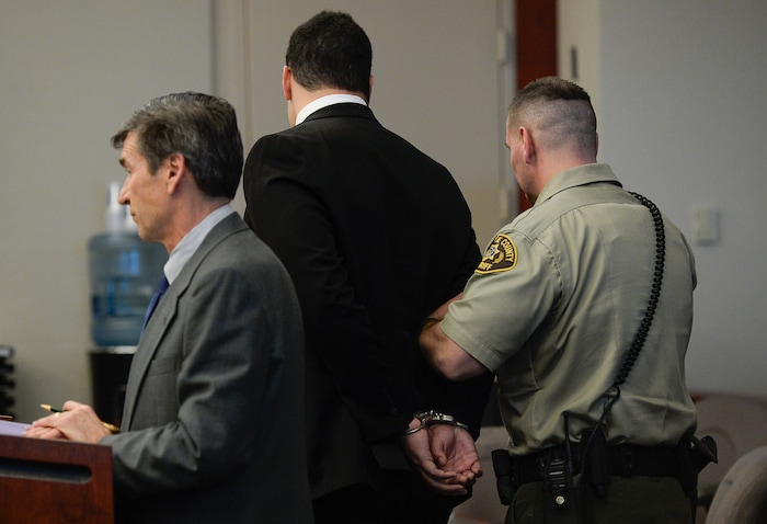 (Francisco Kjolseth  |  The Salt Lake Tribune)  Former Brighton High and University of Southern California linebacker Osa Masina, center, is taken into custody during his sentencing for sexual battery at the Matheson Courthouse in Salt Lake City on Tuesday, Dec. 5, 2017. Masina was sentenced to 365 days in jail, followed by two years on probation.
