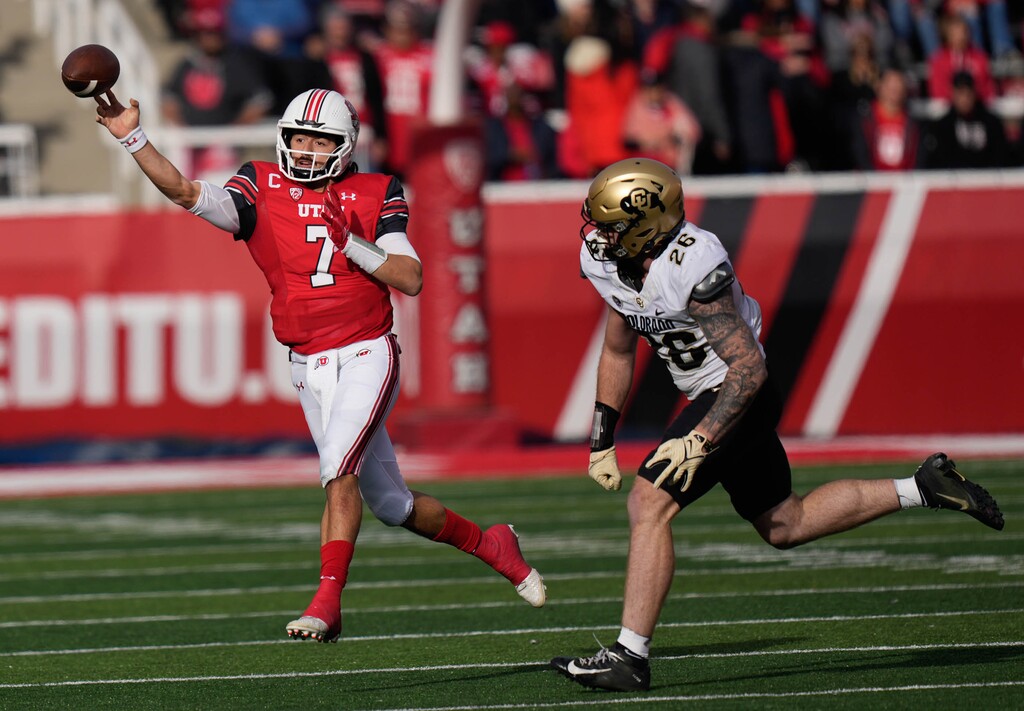 (Francisco Kjolseth | The Salt Lake Tribune) Utah Utes quarterback Cameron Rising (7) makes a pass ahead of Colorado Buffaloes linebacker Carson Wells (26) as the University of Utah hosts the Colorado Buffaloes in Pac-12 football, Friday, Nov. 26, 2021 at Rice-Eccles Stadium.