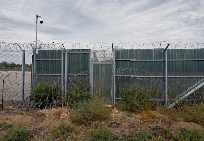 A closed gate of the heavily guarded camp at Serbia's border with Hungary, near the Horgos border crossing, Serbia, Tuesday, Sept. 19, 2017. The European Union border that saw hundreds of thousands of migrants enter freely in 2015 has since become a sealed fortress with two rows of fence and closed camps that the United Nations have described as ''in effect detention centers.'' (AP Photo/Darko Vojinovic)
