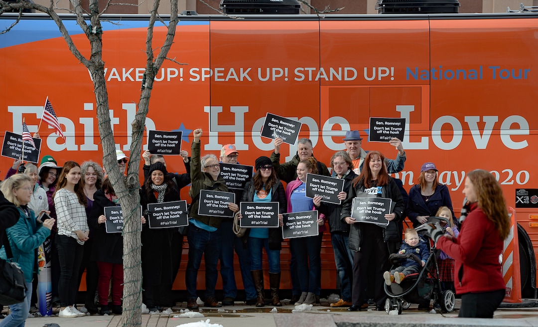 (Francisco Kjolseth  |  The Salt Lake Tribune) A coalition of Republicans, Democrats and independents gather for photos in front of the Vote Common Good bus, following a press event in front of Sen. Mitt Romney's office at the Wallace F. Bennett Federal building in Salt Lake City on Thursday, Jan. 16, 2020, asking for a fair impeachment trial.