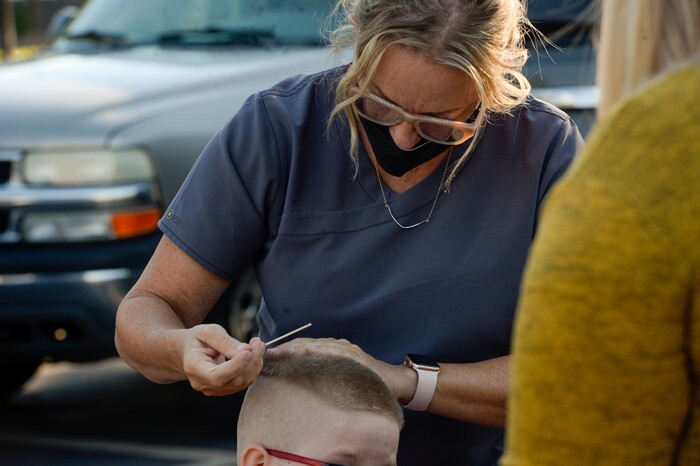 (Chris Samuels | The Salt Lake Tribune) A camper receives a lice check before leaving for Camp Hope, a camp run by the Salt Lake District Attorney’s office for kids who have been victims of violence, Monday, June 28, 2021.