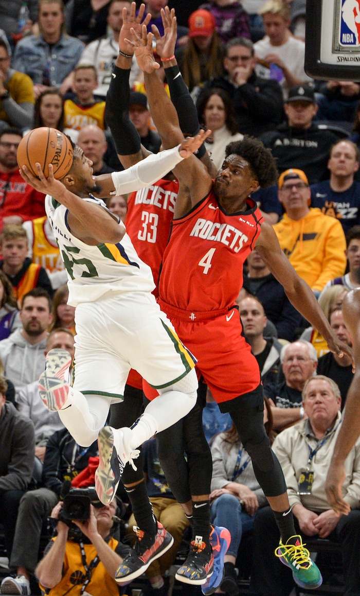 (Leah Hogsten  |  The Salt Lake Tribune) Utah Jazz guard Donovan Mitchell (45) tries to shoot around Houston Rockets forward Robert Covington (33) and Houston Rockets forward Danuel House Jr. (4). The Utah Jazz lost to the Houston Rockets 110-120 at Vivint Arena, Feb. 22, 2020.