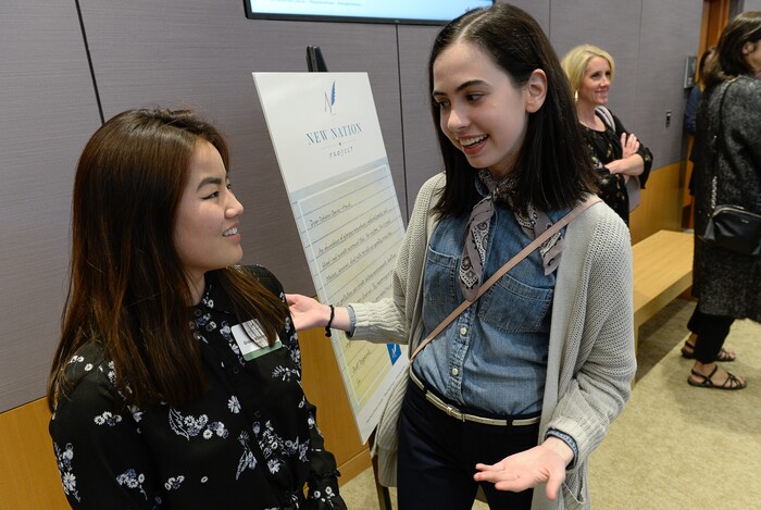 (Francisco Kjolseth  |  The Salt Lake Tribune)  Students Gracie Kilminster, 17, left, and Camille Whisenant, 18, both students at Highland High realize for the first time that a fellow Highland Ram won a ticket to Hamilton on Thursday, April 19, 2018. Kilminster and Whisenant both wrote essays to Mayor Jackie Biskupski as part of the New Nation Project where kids were challenged to write to politicians to educate them on topics important to them and propose a solution. 