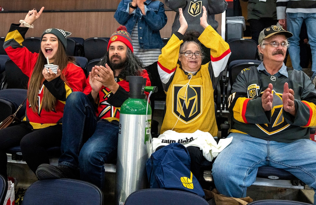 (Rick Egan | The Salt Lake Tribune) Madii and Joseph cheer for the Las Vegas Golden Knights, along with their parents, Jeff and Tina Lewis, during an NHL preseason game between the Los Angeles Kings and the Las Vegas Golden Knights, Thursday, Sept. 30, 2021. The game was Tina's first night out after coming home from the hospital from over six months of complications of COVID-19. The Lewis family are avid hockey fans and their favorite team is the Golden Knights.