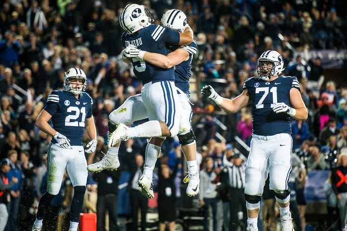 (Chris Detrick  |  The Salt Lake Tribune)  Brigham Young Cougars running back Ula Tolutau (5) celebrates with Brigham Young Cougars offensive lineman Thomas Shoaf (59) after scoring a touchdown during the game LaVell Edwards Stadium Friday, October 6, 2017. 