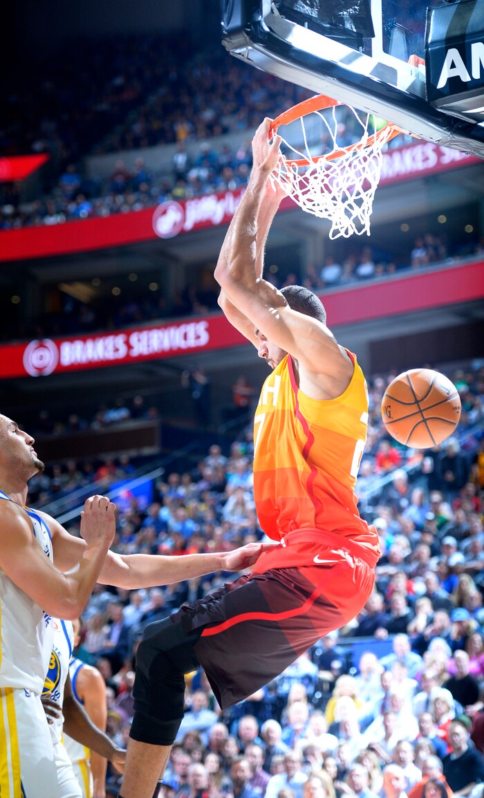 (Steve Griffin  |  The Salt Lake Tribune) Utah Jazz center Rudy Gobert (27) hangs on the rim after trowing down a reverse jam during the Utah Jazz versus Golden State Warriors at Vivint Smart Home Arena in Salt Lake City Tuesday January 30, 2018.