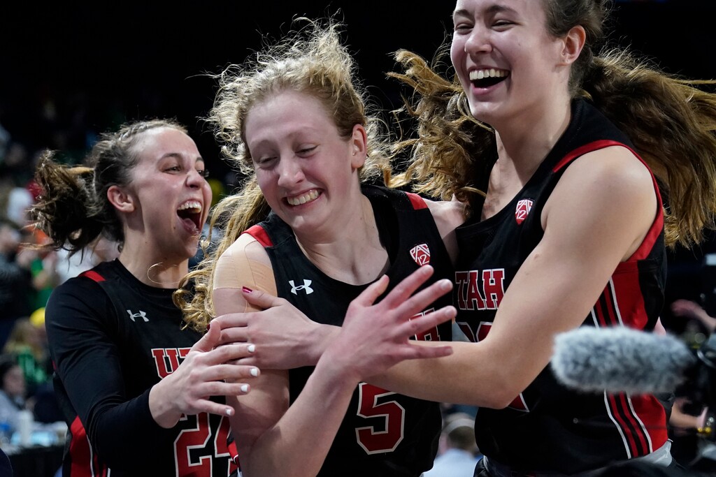 (John Locher | AP) From left, Utah's Kennady McQueen (24), Gianna Kneepkens (5) and Jenna Johnson (22) celebrate after defeating Oregon in an NCAA college basketball game in the semifinal round of the Pac-12 women's tournament Friday, March 4, 2022, in Las Vegas.