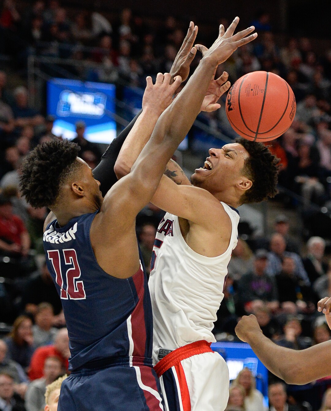 (Francisco Kjolseth  |  The Salt Lake Tribune)  Fairleigh Dickinson Knights forward Kaleb Bishop (12) puts the pressure on Gonzaga Bulldogs forward Brandon Clarke (15) as Gonzaga faces Fairleigh Dickinson in their first round menÕs NCAA March Madness tournament game at Vivint Smart Home Arena in Salt Lake City on Thursday, March 21, 2019.