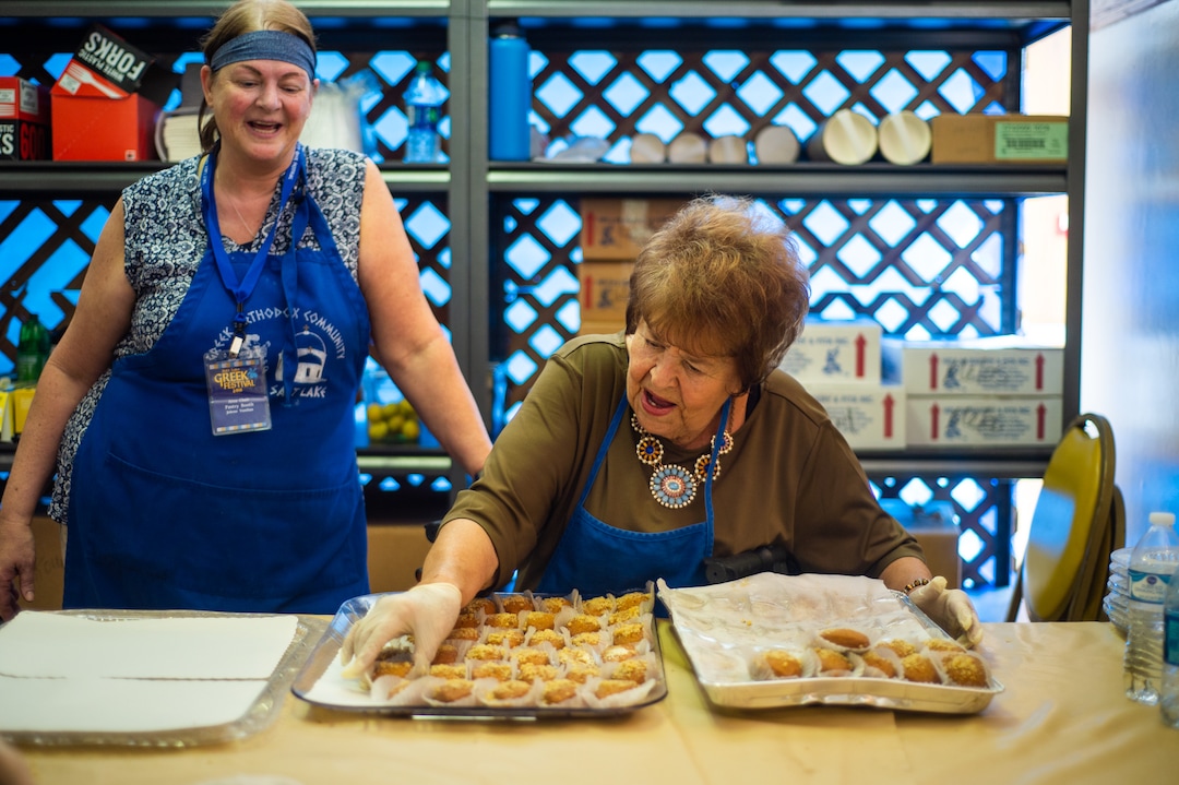 (Rachel Molenda  |  The Salt Lake Tribune) Jolene Vasilias, left, and Lorlee Karpakis, right, chat as Karpakis prepares melomakarona at the Salt Lake Greek Festival on Saturday, Sept. 8, 2018.