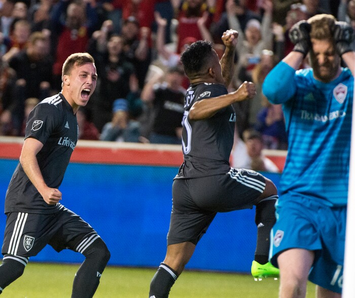 (Rick Egan  |  The Salt Lake Tribune) 
  Real forward Corey Baird (27) celebrates as Real Salt Lake forward Joao Plata (10) scores a goal for Salt Lake as Colorado Rapids goalkeeper Zac MacMath (18) reacts, in MLS soccer action, between Real Salt Lake and Colorado Rapids,  at Rio Tinto Stadium, Saturday, April 21, 2018.


