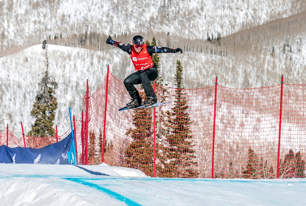 Mick Dierdorff clears a jump in the men's snowboard cross final at the Freestyle Ski and Snowboard World Championships, Friday, Feb. 1, 2019, in Solitude, Utah. (AP Photo/Tyler Tate)