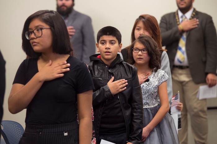 (Scott Sommerdorf   |  The Salt Lake Tribune)   Children, including Haitham Layth Mohammed Ali, center, recite the pledge of allegiance prior to a ceremony in recognition of children who have obtained citizenship through their parents, Thursday, December 28, 2017. Some children were adopted by U.S. citizen parents; others derived citizenship when their immigrant parents became naturalized citizens.