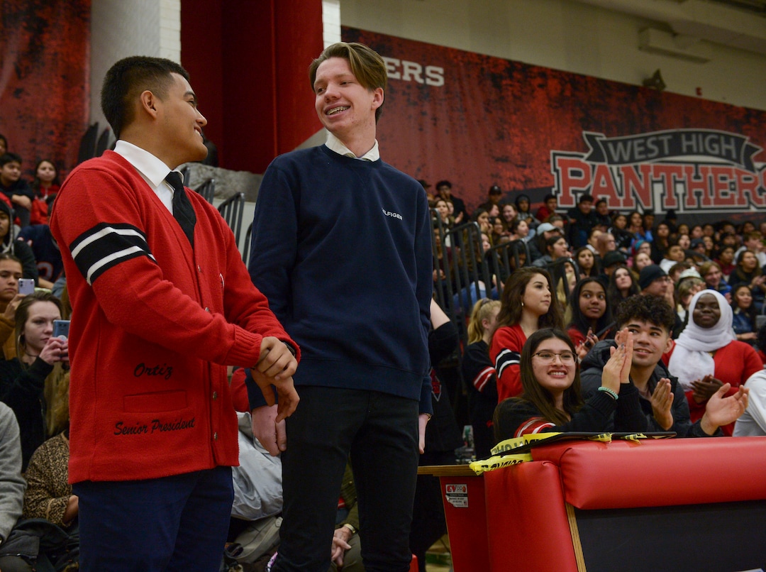(Leah Hogsten  |  The Salt Lake Tribune) l-r West High School students, Felix Ortiz and Grant Dunkley smile at each other as they are recognized for saving the life of Assistant Attorney General David Carlson, center, during an assembly at the school, Jan. 17, 2020. On February 19, 2019, Ortiz and Dunkley both pulled over to assist Carlson out of  his overturned car on the 600 North bridge in Salt Lake City where Ortiz performed life-saving CPR until first responders arrived on the scene.