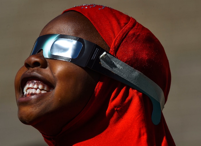 (Steve Griffin  |  The Salt Lake Tribune) Meadowlark Elementary School first-grader Dowley Super smiles as he watches The Great Eclipse during the Salt Lake School District's first day of the 2017-2018 school year. STEAM teacher-coordinator Wendi Laurence who formerly worked at NASA has been planning an event around the eclipse. All students had glasses to view the event and many had lunch outside at the Salt Lake City school Monday August 21, 2017.