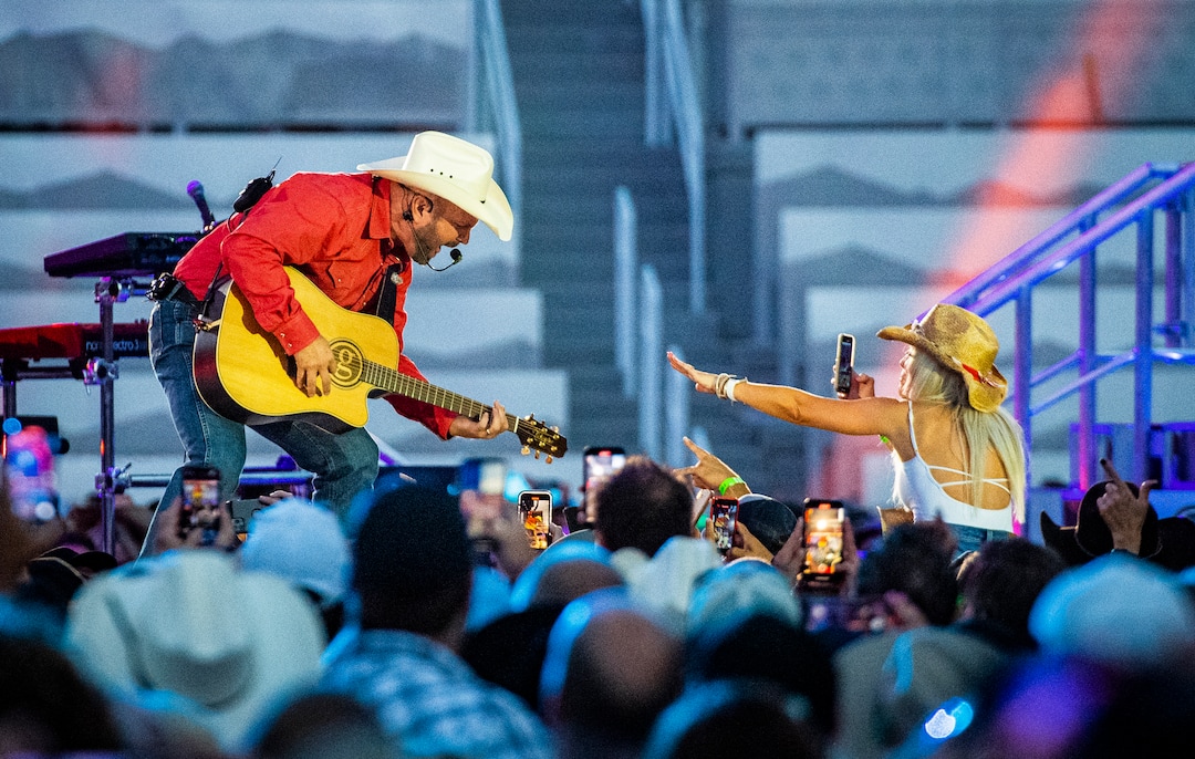 (Isaac Hale | Special to The Tribune) Garth Brooks interacts with a fan as he performs with his band during a stop on their stadium tour held at Rice-Eccles Stadium in Salt Lake City on Saturday, July 17, 2021.