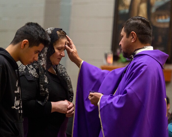 (Rick Egan  |  The Salt Lake Tribune)     Members of the Our Lady of Guadalupe Catholic Church receive the ashes from the Rev. Jose Fidel Barrera-Cruz during Ash Wednesday Mass in Salt Lake City on Wednesday, March 6, 2019.